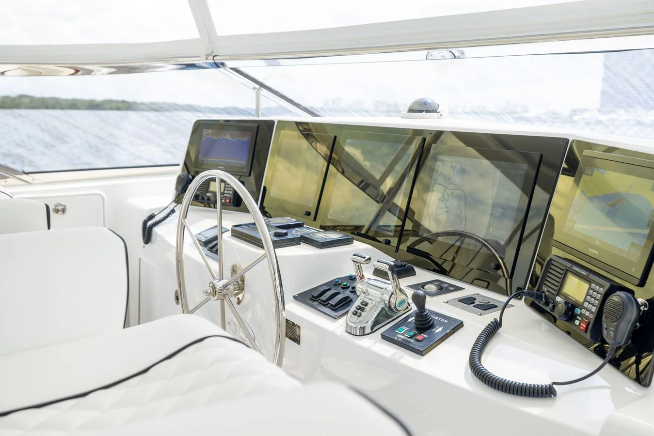 The helm station features advanced navigation equipment and luxurious seating. aboard OUTRAGEOUS Yacht for Sale