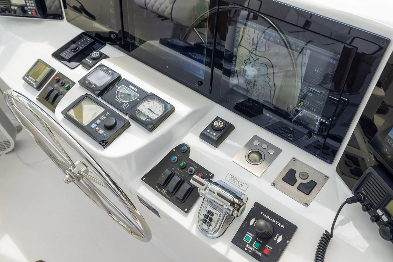 The helm station features advanced navigation and control systems for precise yacht handling. aboard OUTRAGEOUS Yacht for Sale