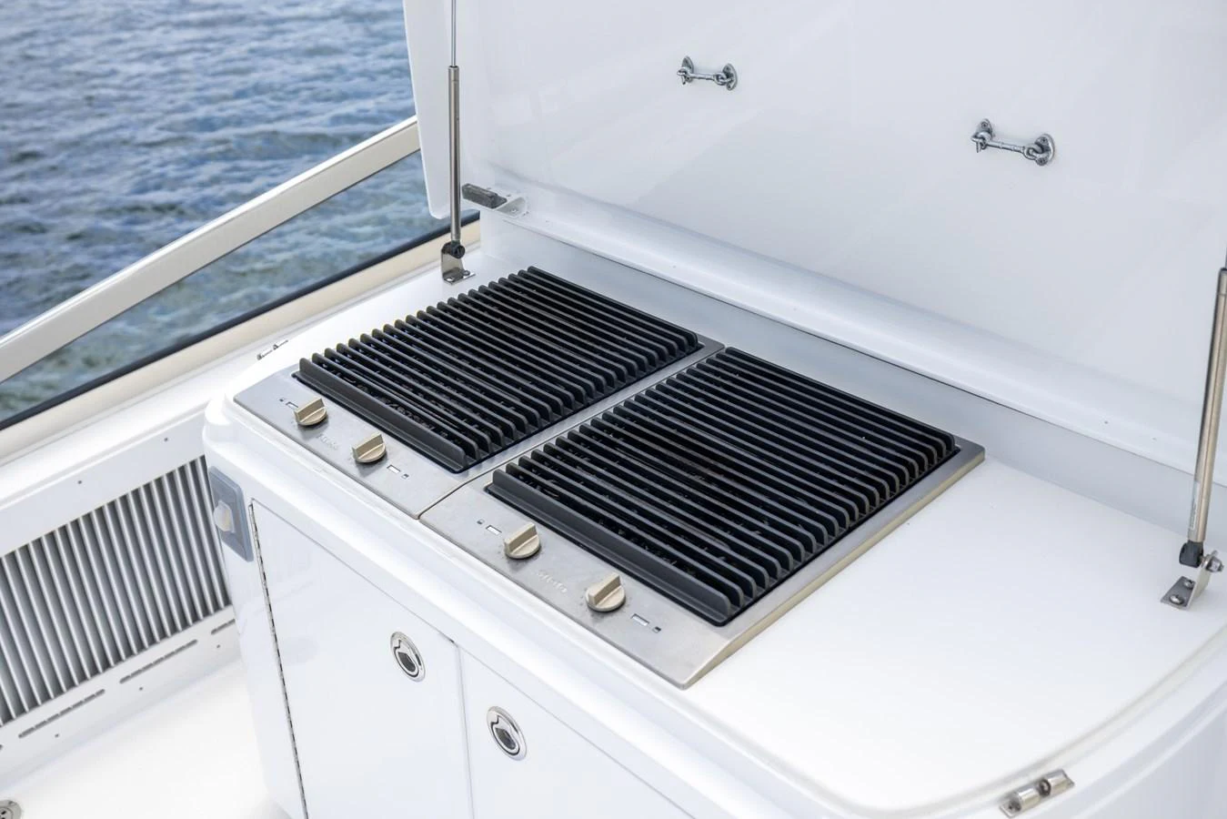 The yacht features a sleek built-in grill on the deck, perfect for outdoor dining. aboard OUTRAGEOUS Yacht for Sale