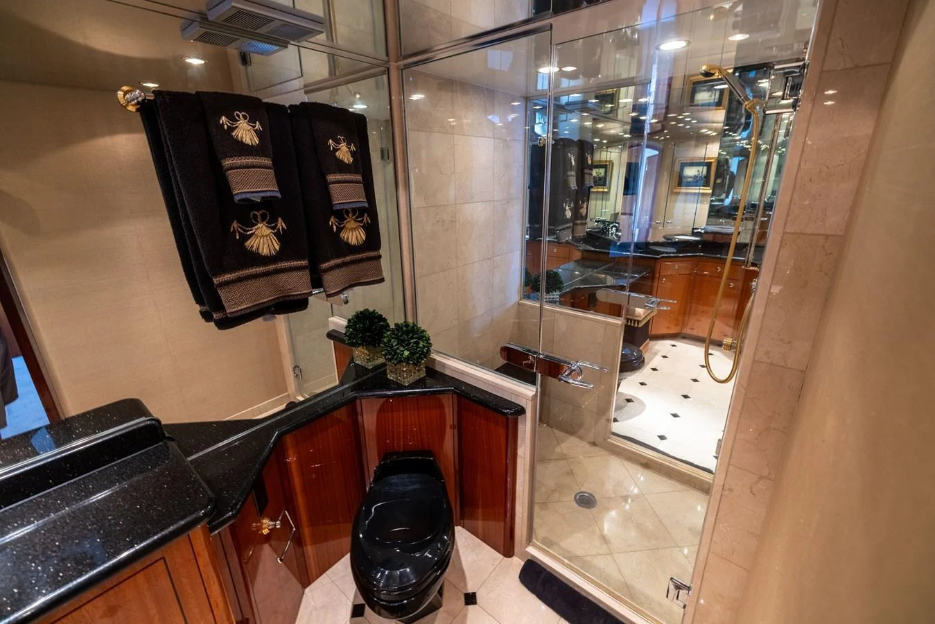 A luxurious yacht bathroom featuring elegant fixtures and a spacious shower area. aboard OUTRAGEOUS Yacht for Sale