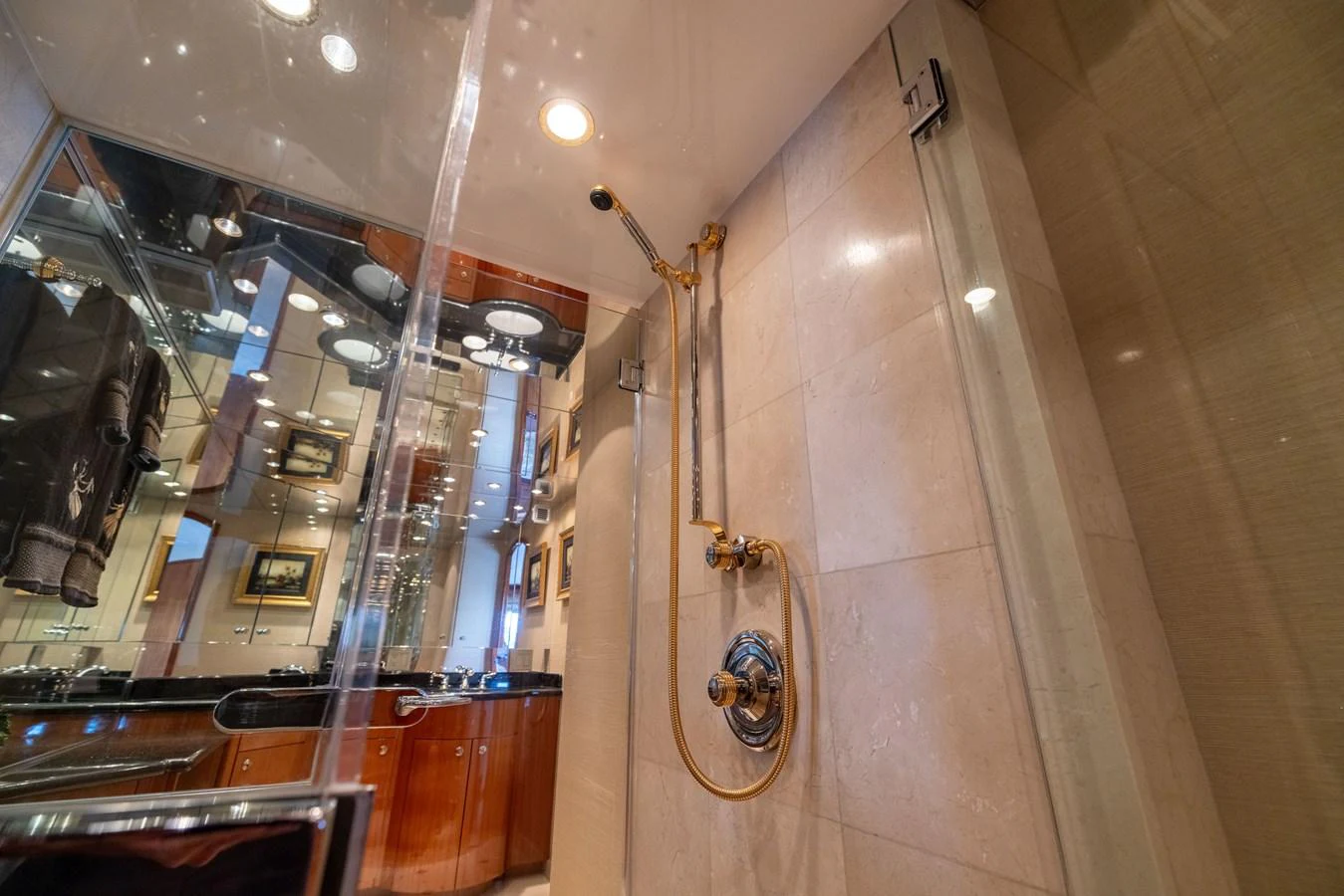 The yacht's bathroom features elegant fixtures and a luxurious shower area. aboard OUTRAGEOUS Yacht for Sale