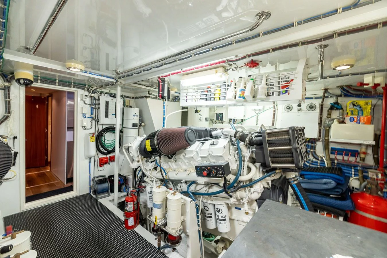 The image showcases a well-organized and clean engine room with advanced machinery and equipment. aboard OUTRAGEOUS Yacht for Sale