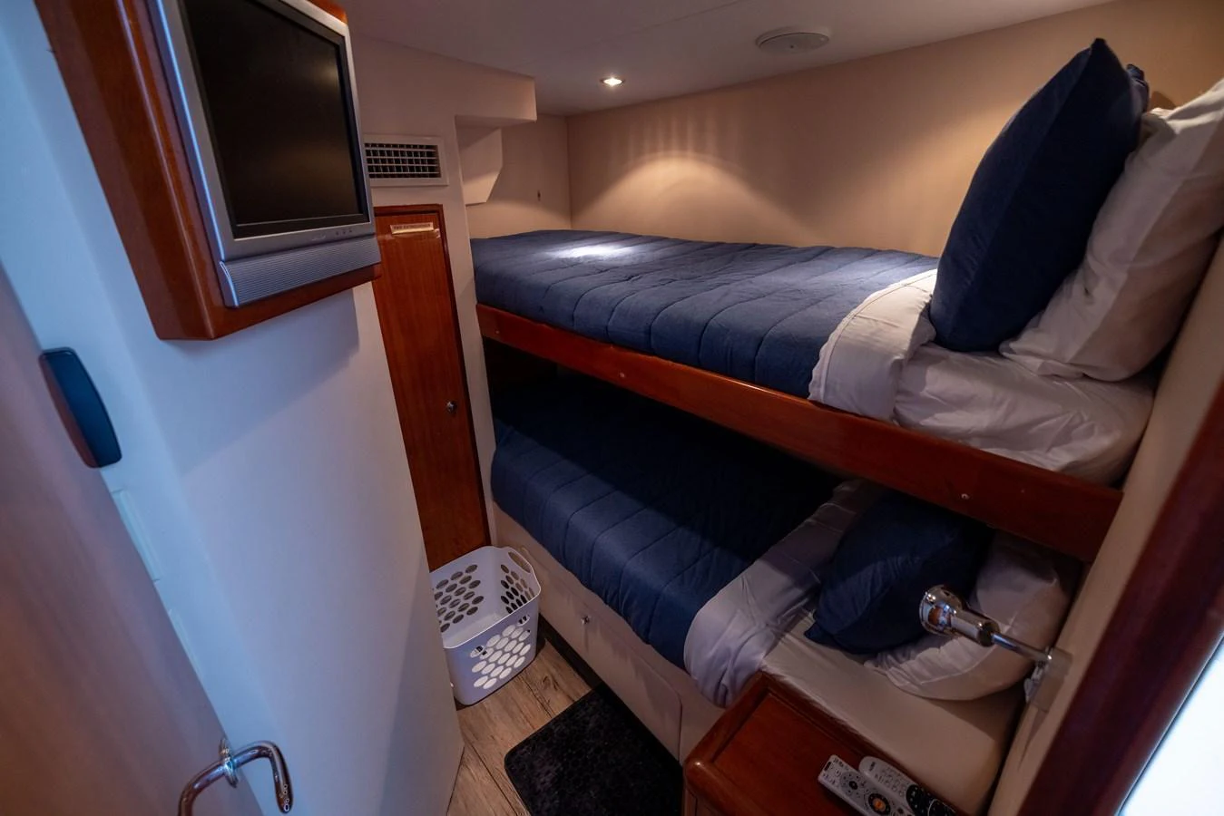 This cozy bunk cabin offers comfortable sleeping arrangements with a modern touch. aboard OUTRAGEOUS Yacht for Sale
