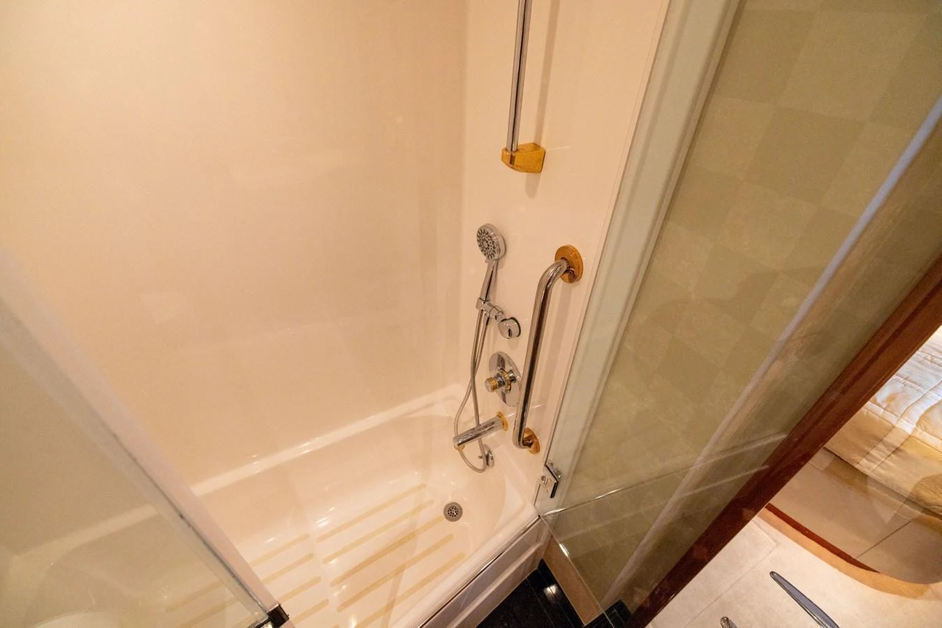 The yacht features a compact and well-appointed bathroom with modern fixtures. aboard OUTRAGEOUS Yacht for Sale