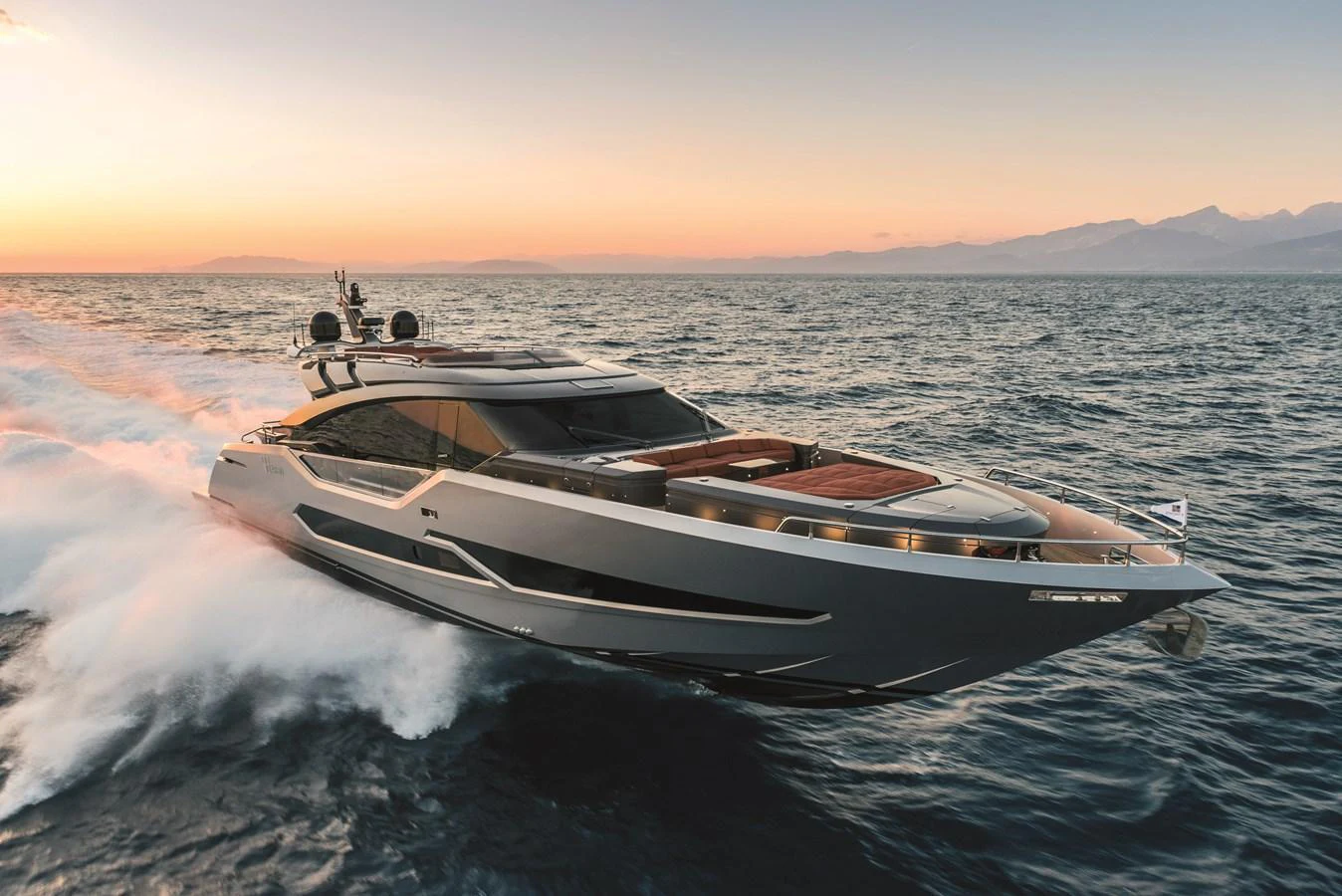 A sleek and modern yacht cruises through the water at sunset, showcasing its elegant design and powerful performance. aboard AB 80 Yacht for Sale