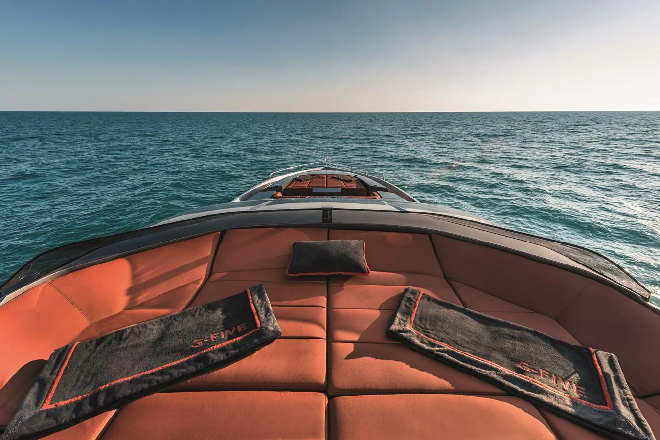 The foredeck features luxurious sun pads with custom towels, offering a perfect spot to relax while cruising. aboard AB 80 Yacht for Sale