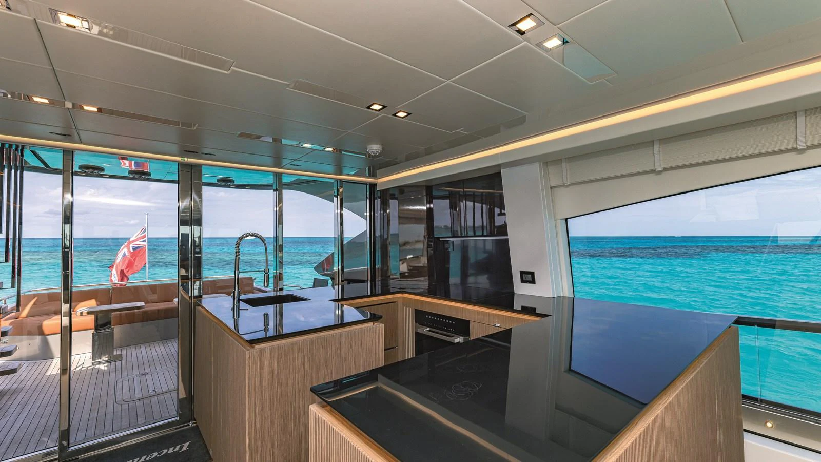 The modern galley offers stunning ocean views through large windows and sliding glass doors. aboard AB 80 Yacht for Sale