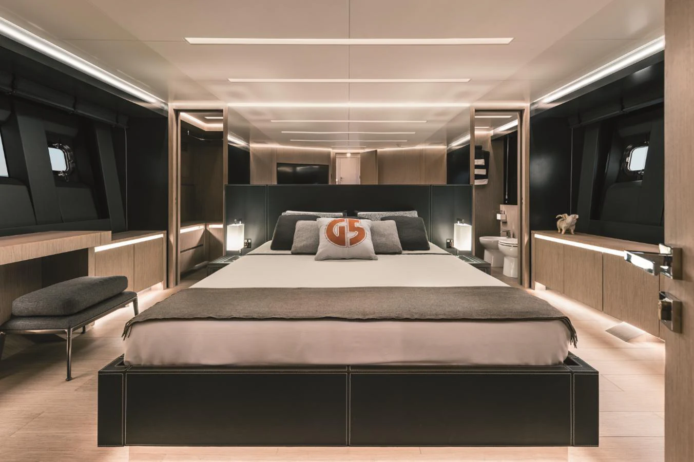 The master stateroom features a spacious bed with modern, elegant decor and ample natural light. aboard AB 80 Yacht for Sale