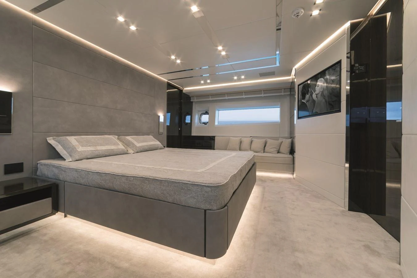 The master stateroom features a luxurious bed, modern lighting, and elegant decor. aboard AB 80 Yacht for Sale