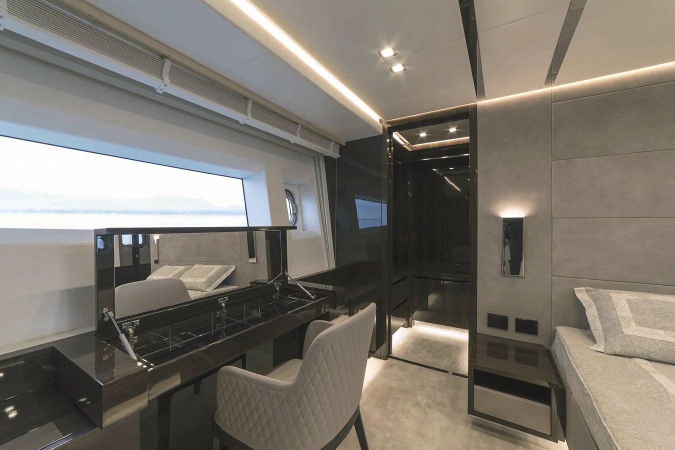 The stateroom features a sleek modern design with a large window offering a serene view of the sea. aboard AB 80 Yacht for Sale