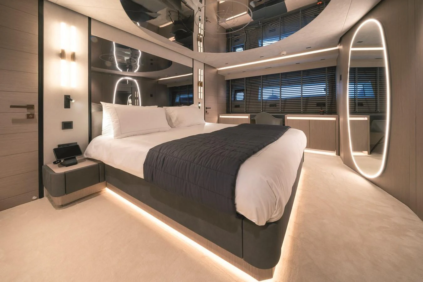 The master stateroom features a luxurious bed with modern lighting and elegant decor. aboard AB 80 Yacht for Sale