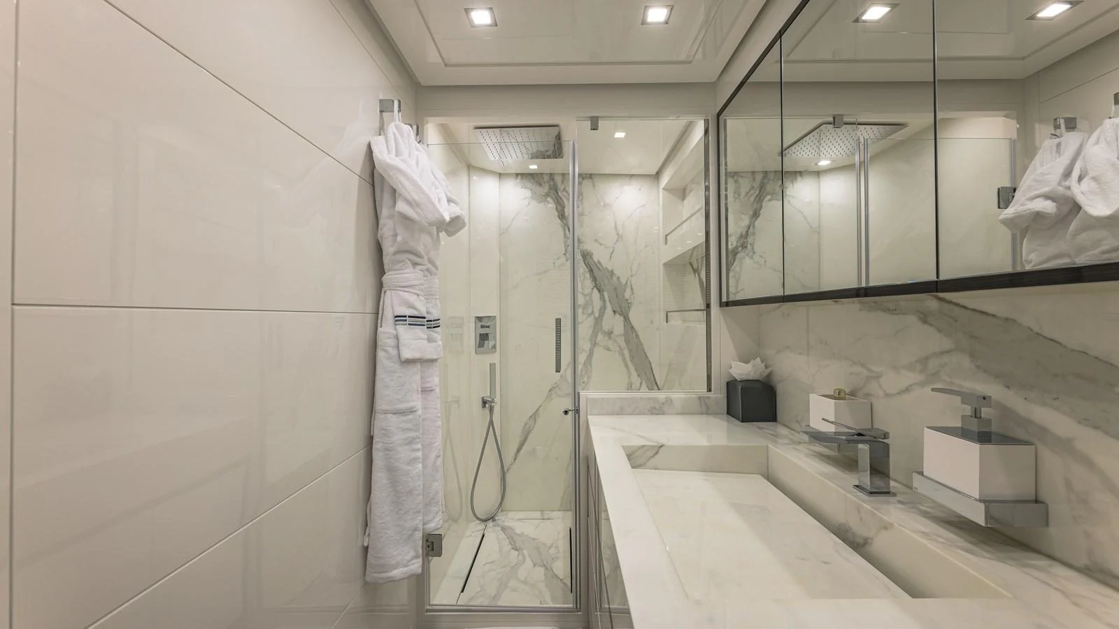 The bathroom features luxurious marble surfaces and modern fixtures, providing a serene and elegant space. aboard AB 80 Yacht for Sale