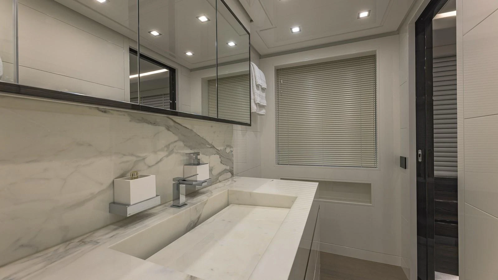 The yacht's bathroom features a sleek design with marble accents and modern fixtures. aboard AB 80 Yacht for Sale