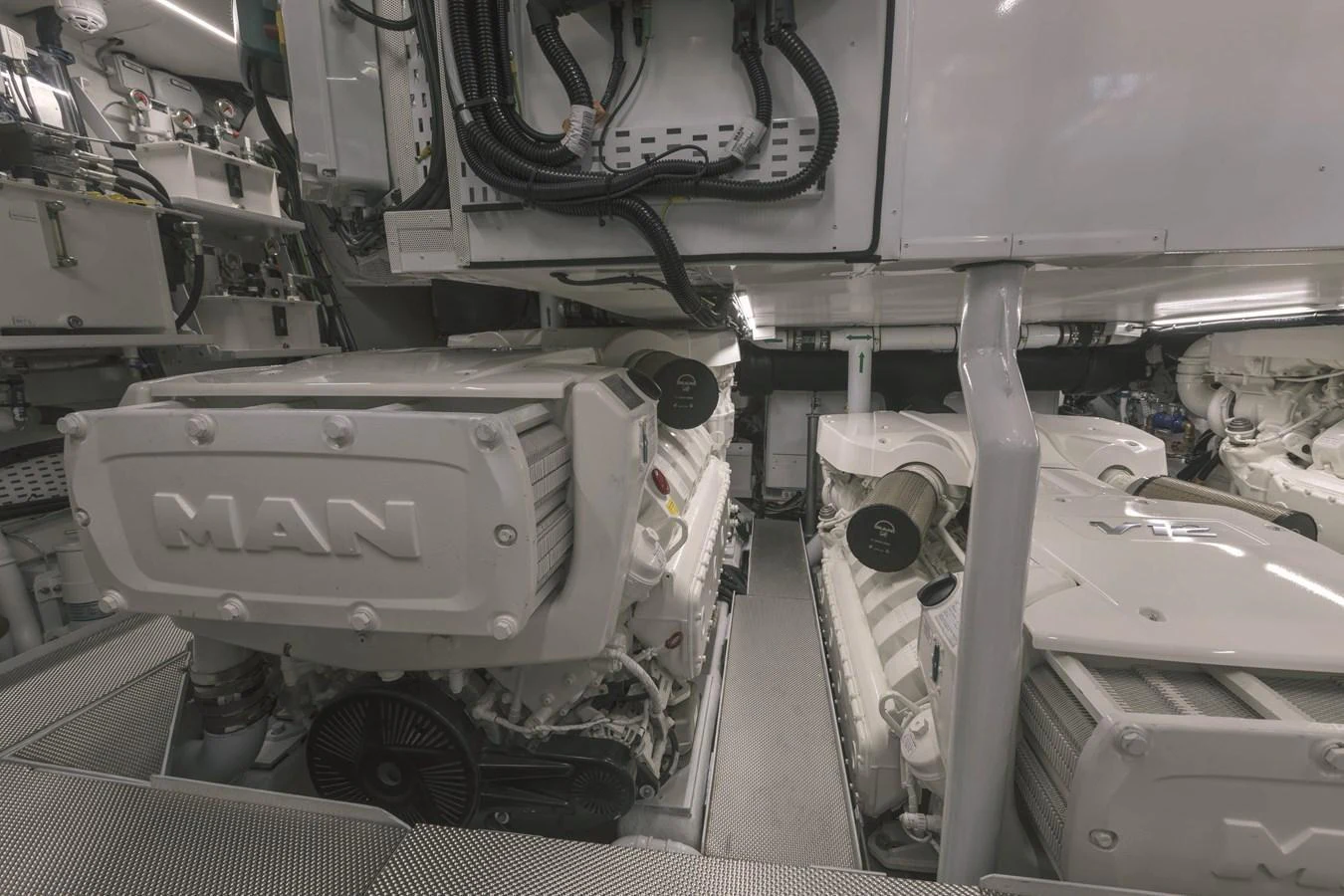The yacht's engine room showcases powerful MAN engines and well-organized mechanical systems. aboard AB 80 Yacht for Sale