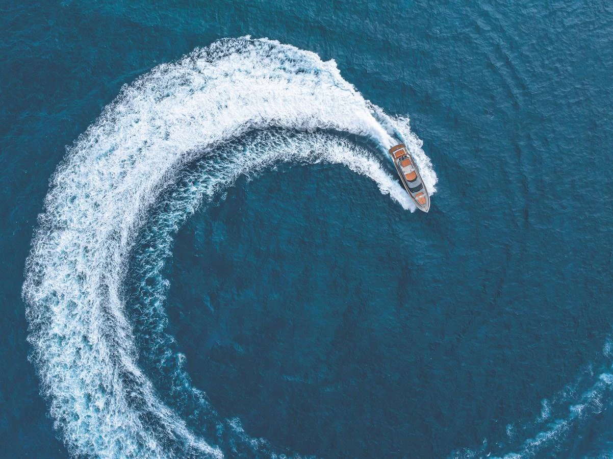 A sleek yacht carves a perfect arc through the deep blue waters, showcasing its agility and power. aboard AB 80 Yacht for Sale