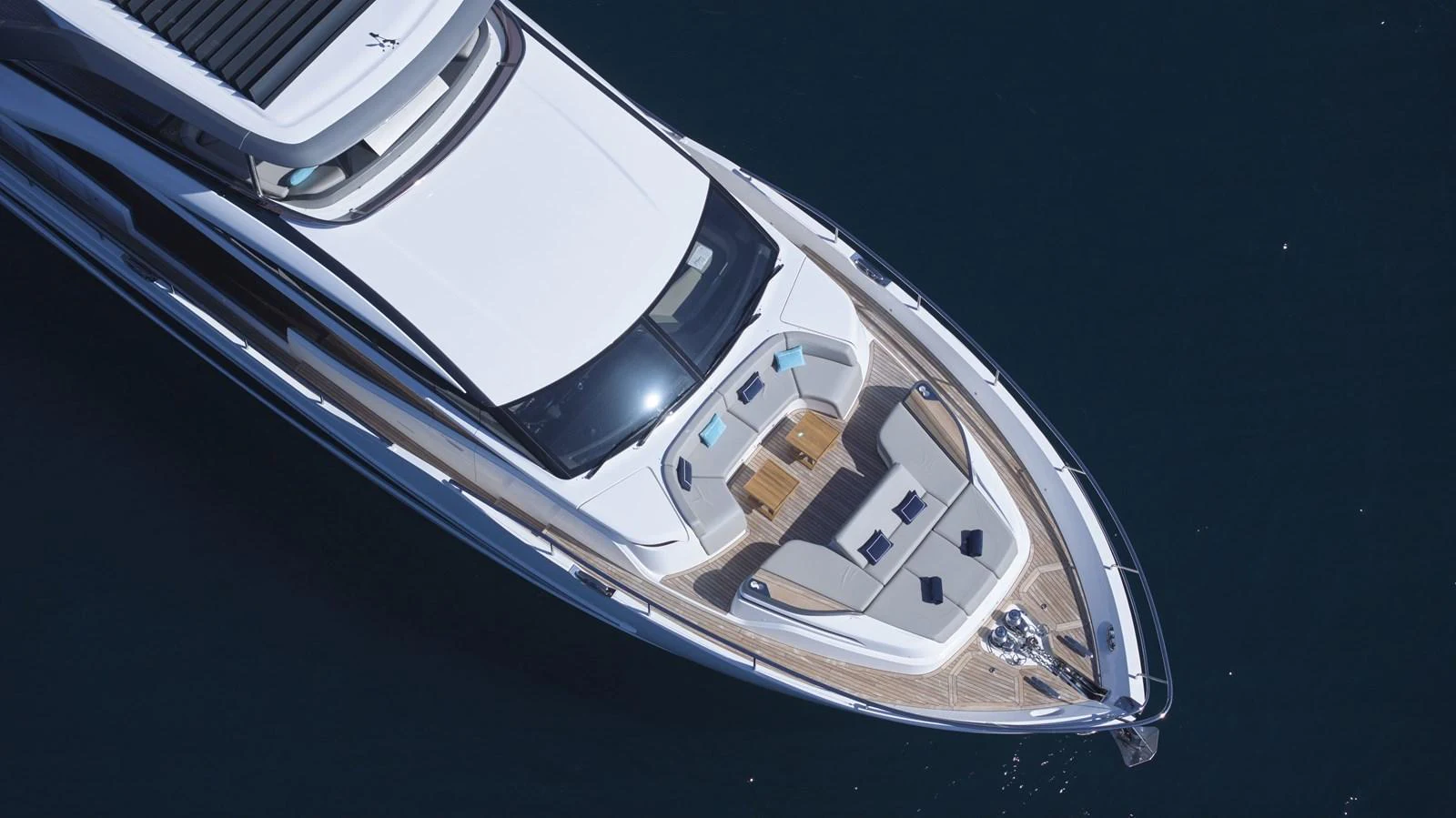 The yacht's foredeck features a luxurious seating area with plush cushions and a sleek, modern design. aboard POLARIS Yacht for Sale