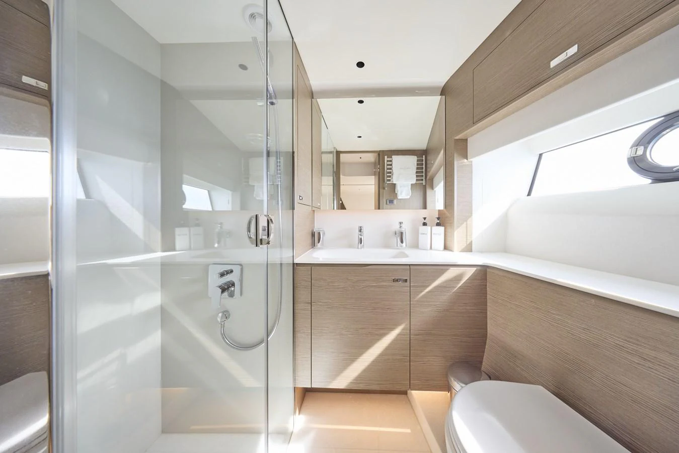 A modern and sleek yacht bathroom with ample natural light and elegant fixtures. aboard POLARIS Yacht for Sale
