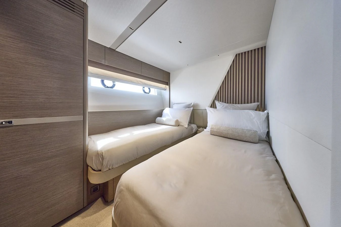 The guest stateroom features two comfortable single beds with modern decor and ample natural light. aboard POLARIS Yacht for Sale