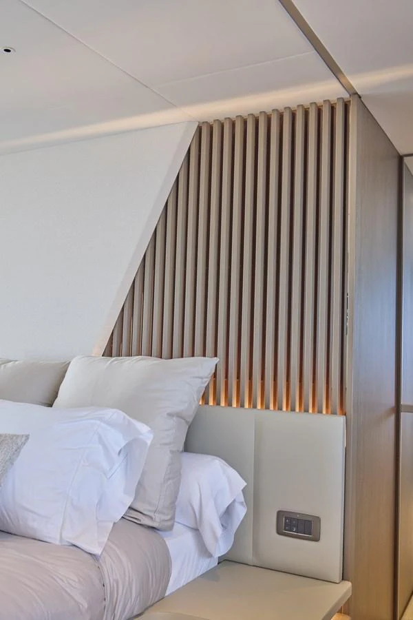 A luxurious stateroom featuring a plush bed with elegant lighting and modern design elements. aboard POLARIS Yacht for Sale