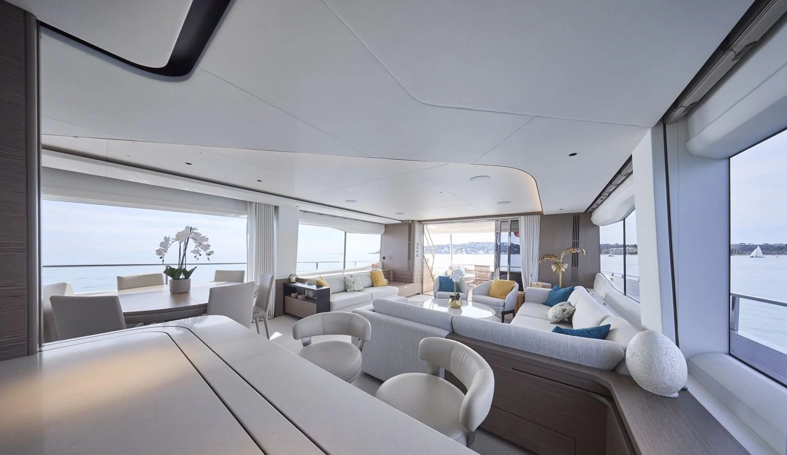 The spacious salon features elegant seating with panoramic views through large windows. aboard POLARIS Yacht for Sale