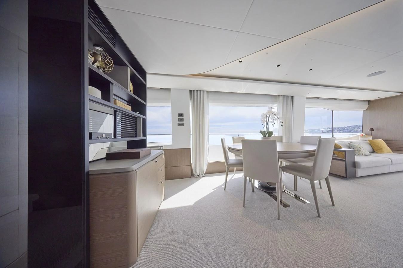 The salon features a spacious and elegantly designed seating area with large windows offering stunning sea views. aboard POLARIS Yacht for Sale