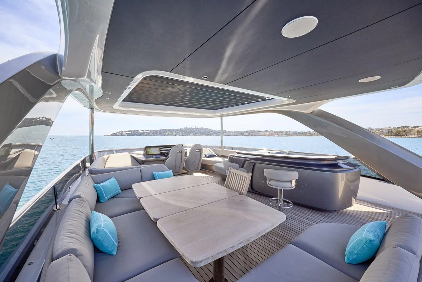 The flybridge features a spacious seating area with a dining table and a jacuzzi, offering stunning views of the water. aboard POLARIS Yacht for Sale