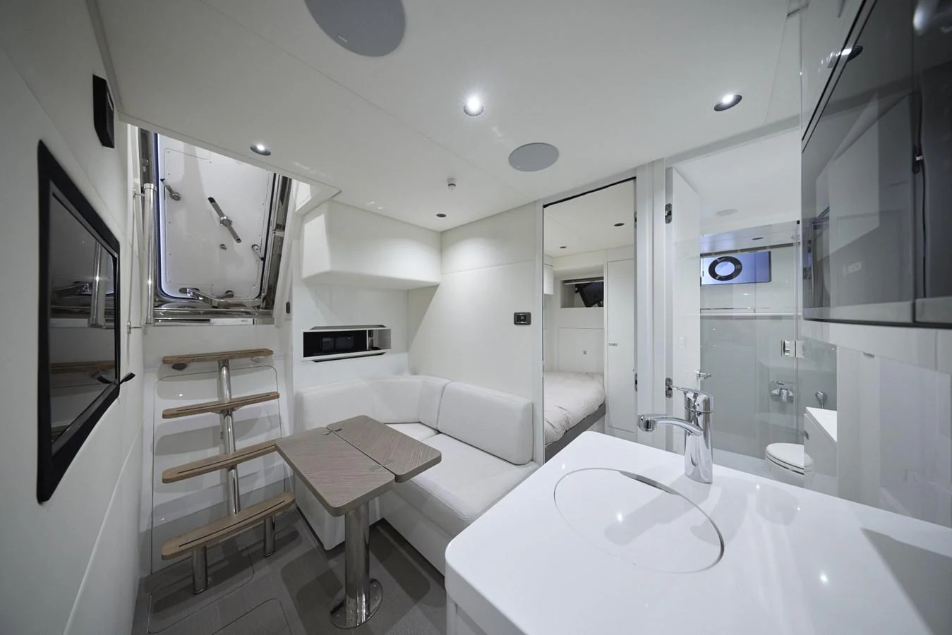 The yacht's interior features a modern and compact living space with a dining area and kitchenette. aboard POLARIS Yacht for Sale