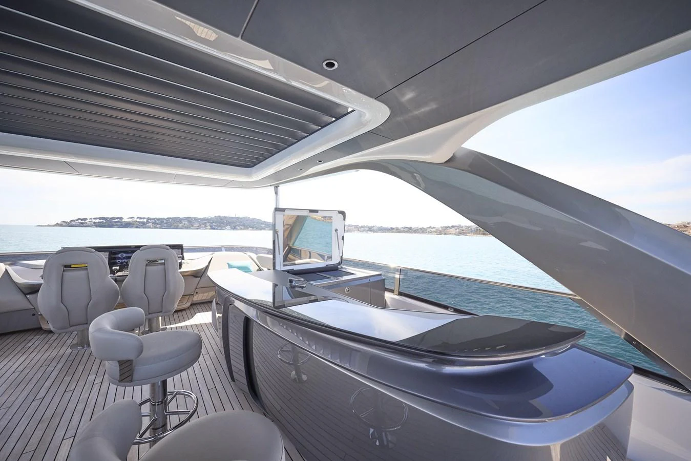 The flybridge features a sleek bar area with modern seating and panoramic views. aboard POLARIS Yacht for Sale