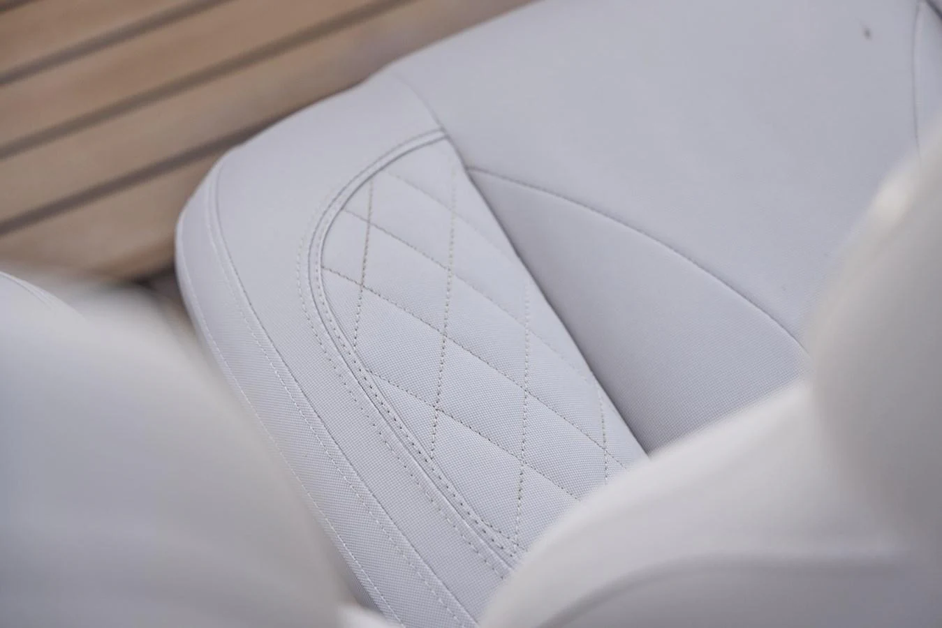 A close-up of a luxurious white leather seat with elegant stitching. aboard POLARIS Yacht for Sale