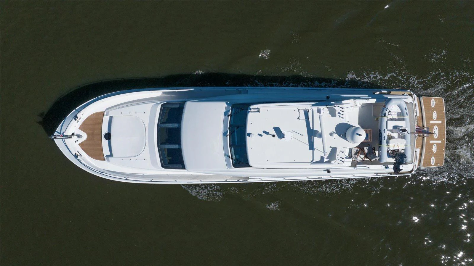 A sleek yacht glides smoothly through the water, showcasing its elegant design from an aerial perspective. aboard OCTOPI Yacht for Sale
