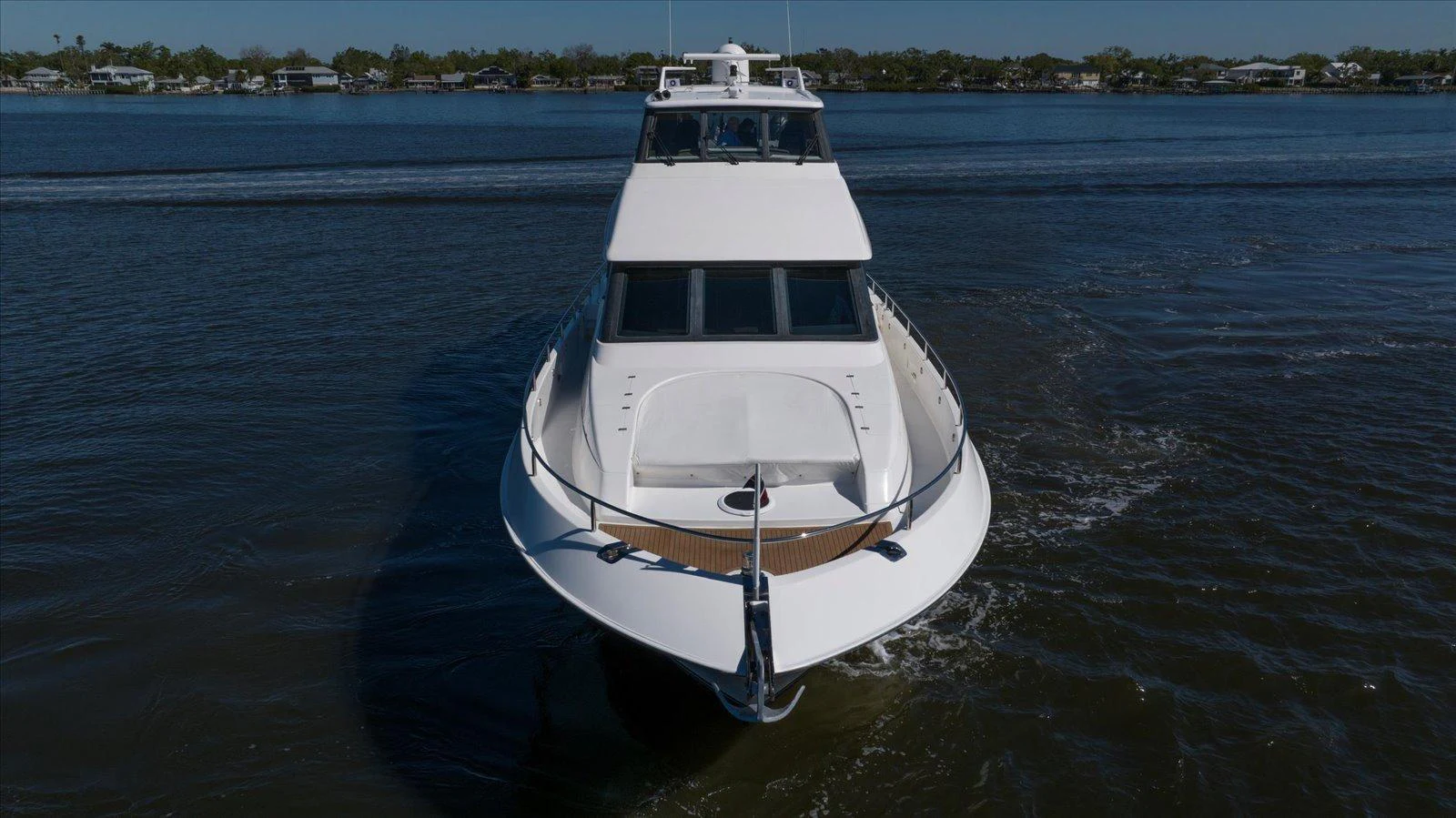 A sleek yacht glides through calm waters, showcasing its elegant design and spacious deck. aboard OCTOPI Yacht for Sale