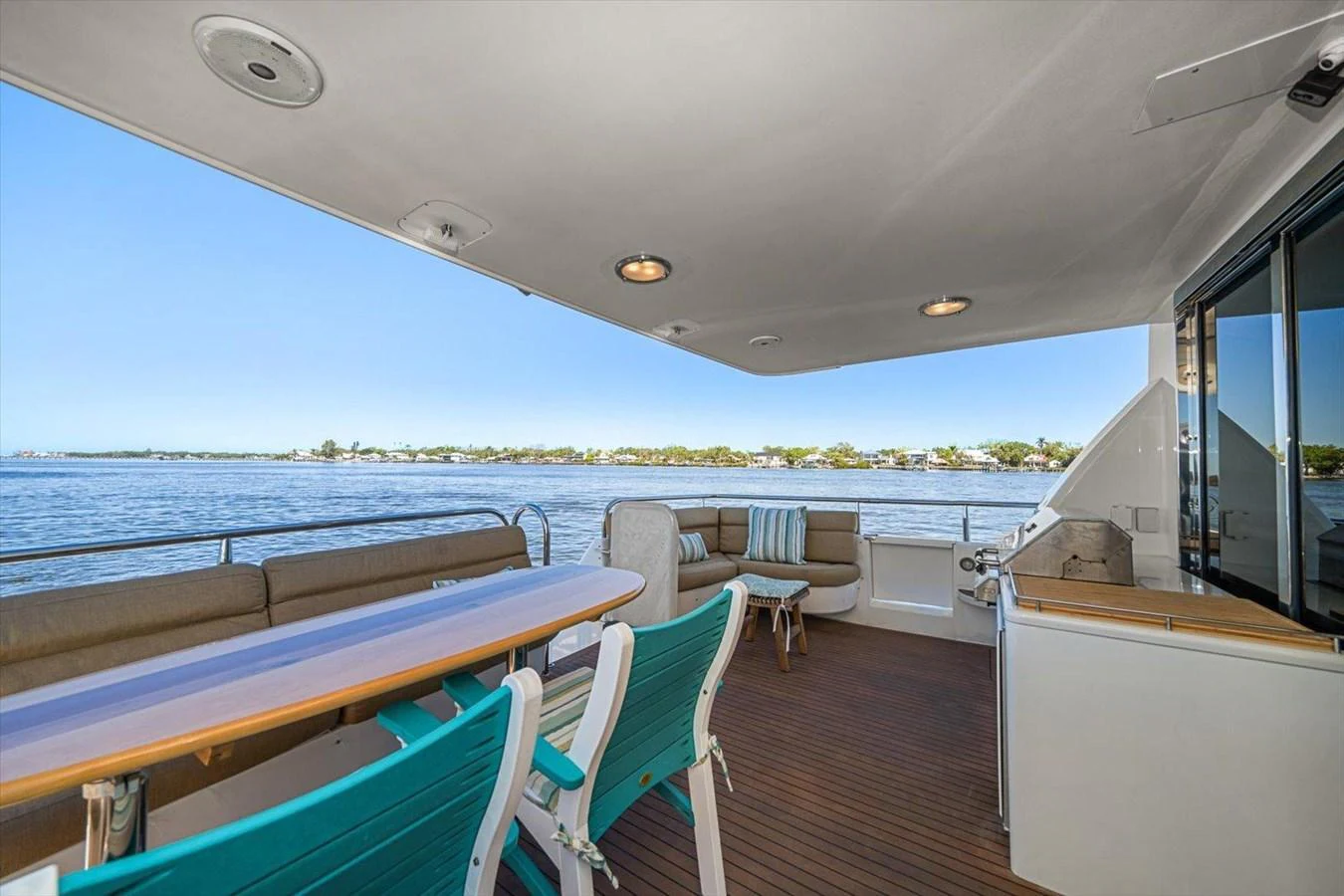 The aft deck offers a comfortable seating area with a scenic view of the water. aboard OCTOPI Yacht for Sale