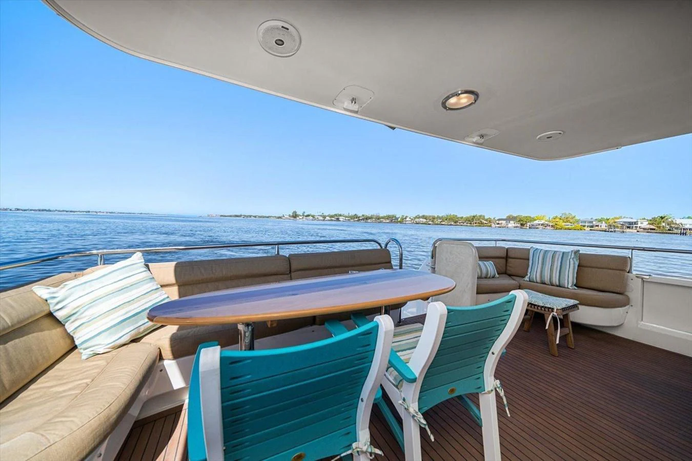 The aft deck features comfortable seating with a dining table, offering a perfect spot to enjoy the sea views. aboard OCTOPI Yacht for Sale