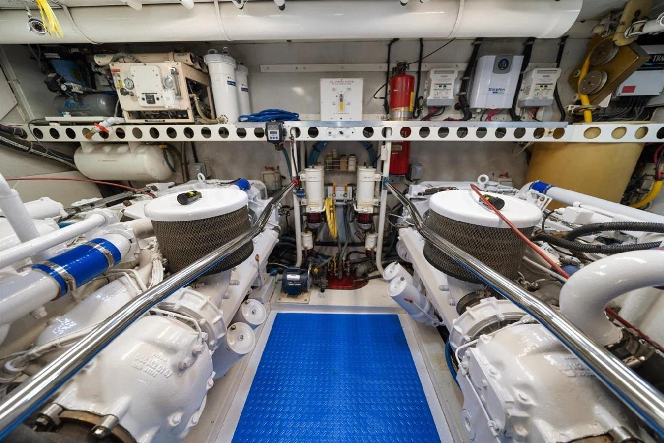 The image showcases the well-maintained engine room of the yacht, featuring dual engines and various mechanical components. aboard OCTOPI Yacht for Sale