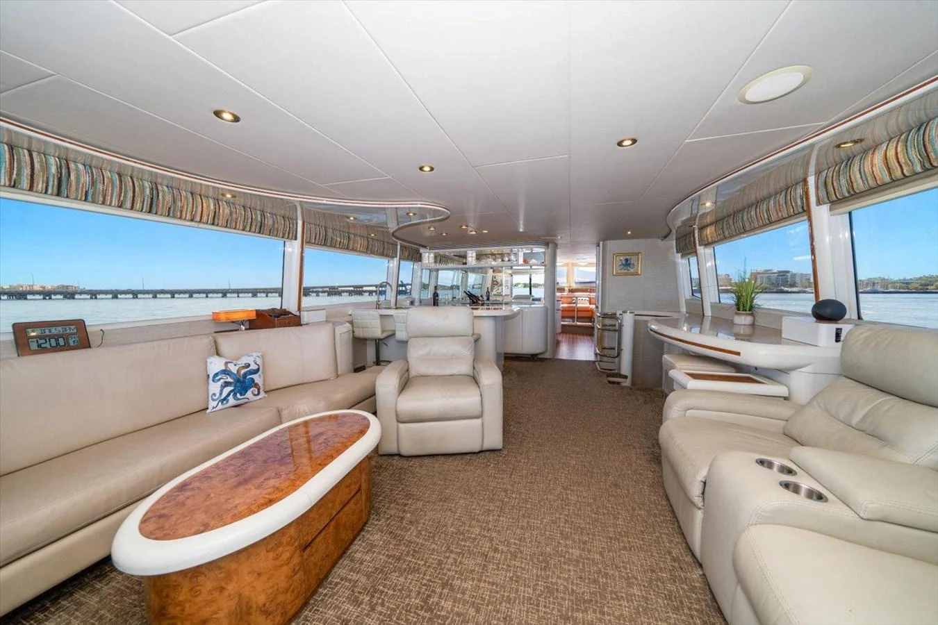 The spacious salon features luxurious seating and panoramic windows offering stunning views. aboard OCTOPI Yacht for Sale