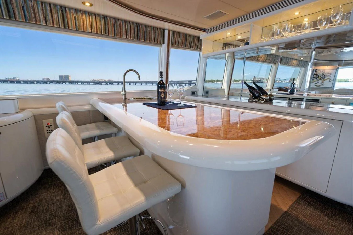 The yacht's interior features a stylish bar area with a marble countertop and comfortable seating. aboard OCTOPI Yacht for Sale