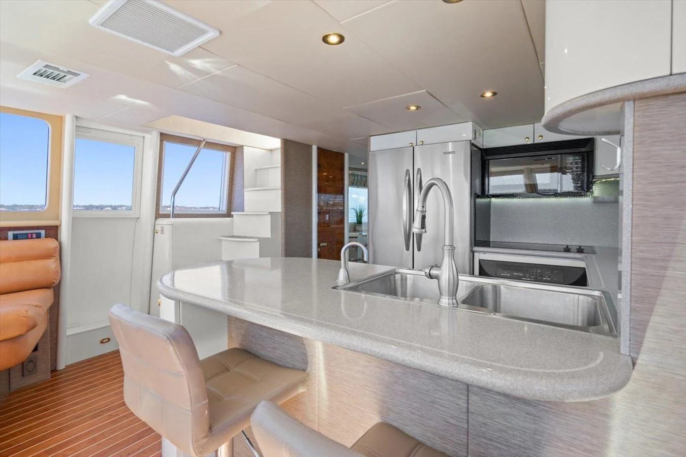 The modern galley features sleek countertops, stainless steel appliances, and comfortable seating. aboard OCTOPI Yacht for Sale