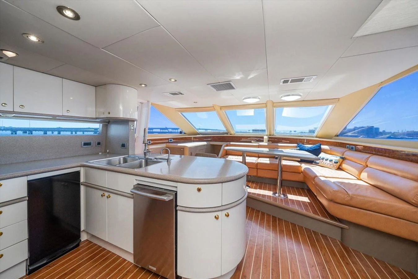 The yacht's galley features modern appliances and a spacious seating area with panoramic windows. aboard OCTOPI Yacht for Sale