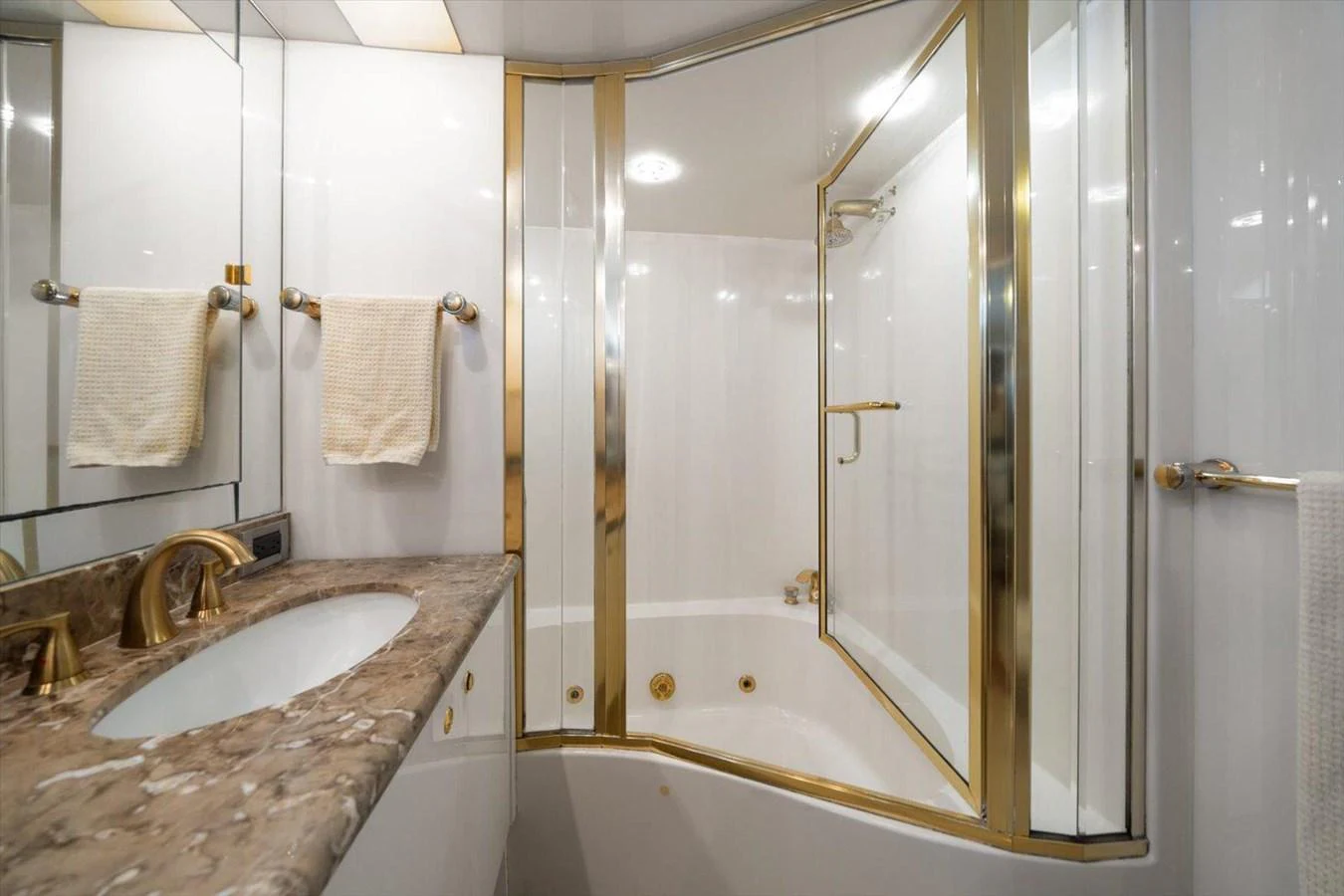 The yacht's bathroom features a luxurious design with gold accents and a marble countertop. aboard OCTOPI Yacht for Sale