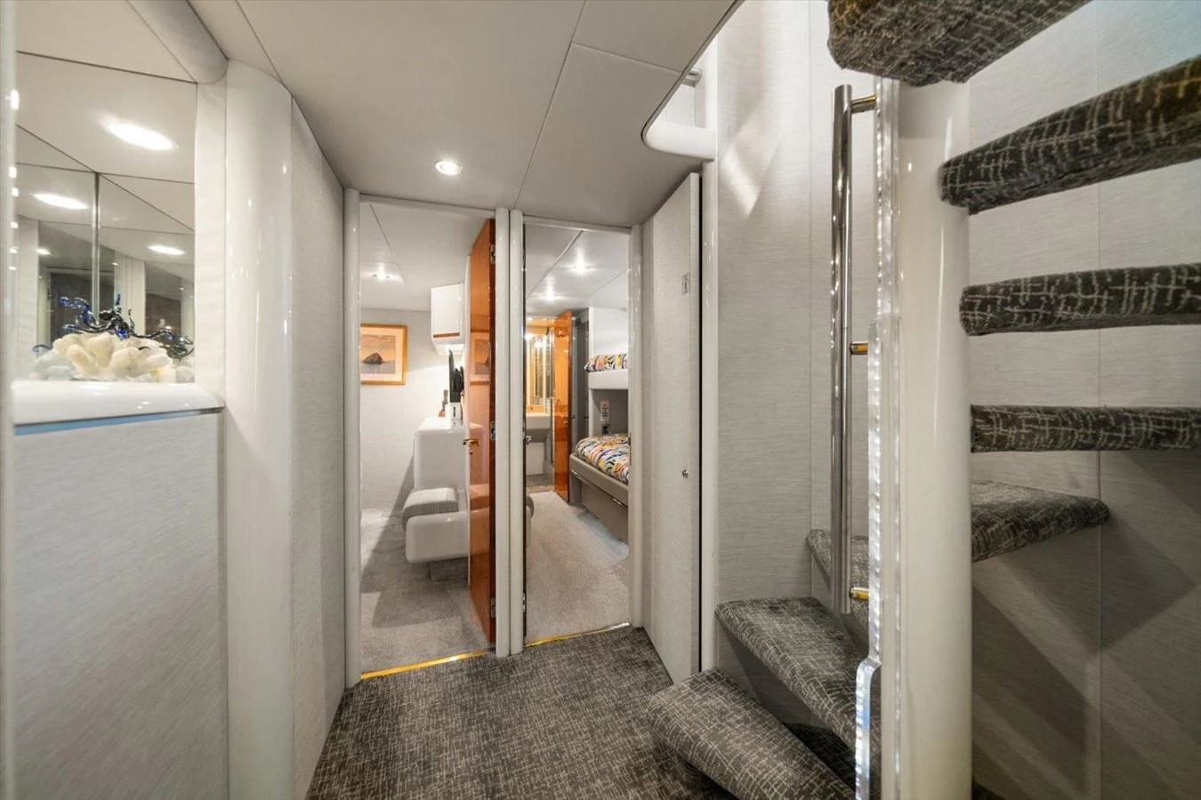 The yacht's interior features a modern and elegant design with a staircase leading to different levels. aboard OCTOPI Yacht for Sale