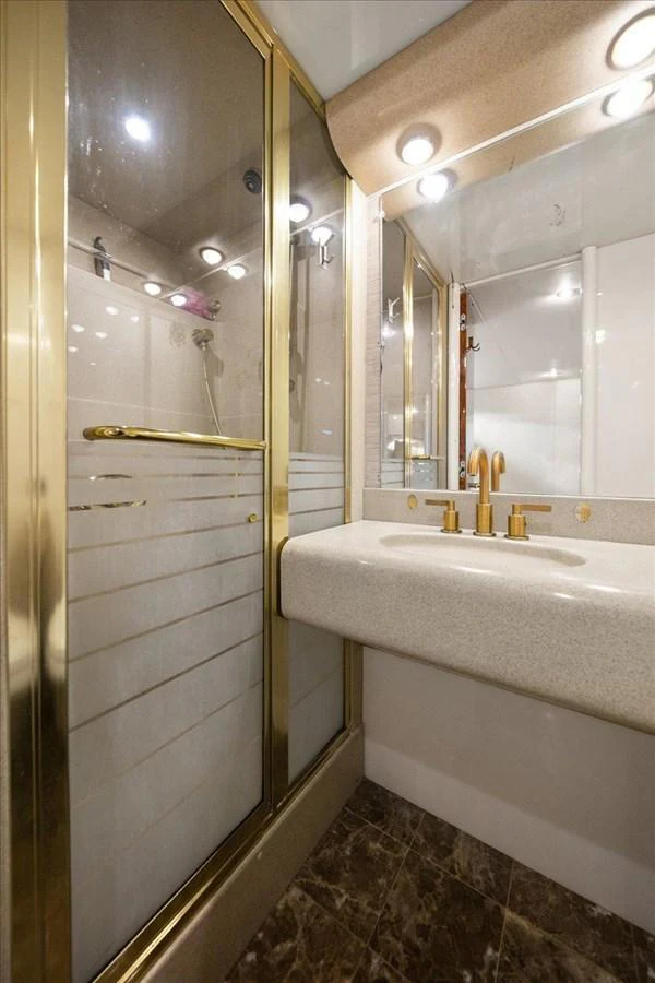 A luxurious yacht bathroom featuring a glass-enclosed shower and elegant fixtures. aboard OCTOPI Yacht for Sale