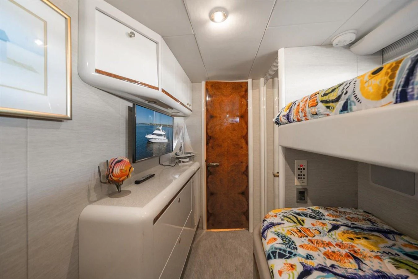 A cozy cabin with bunk beds and modern furnishings. aboard OCTOPI Yacht for Sale