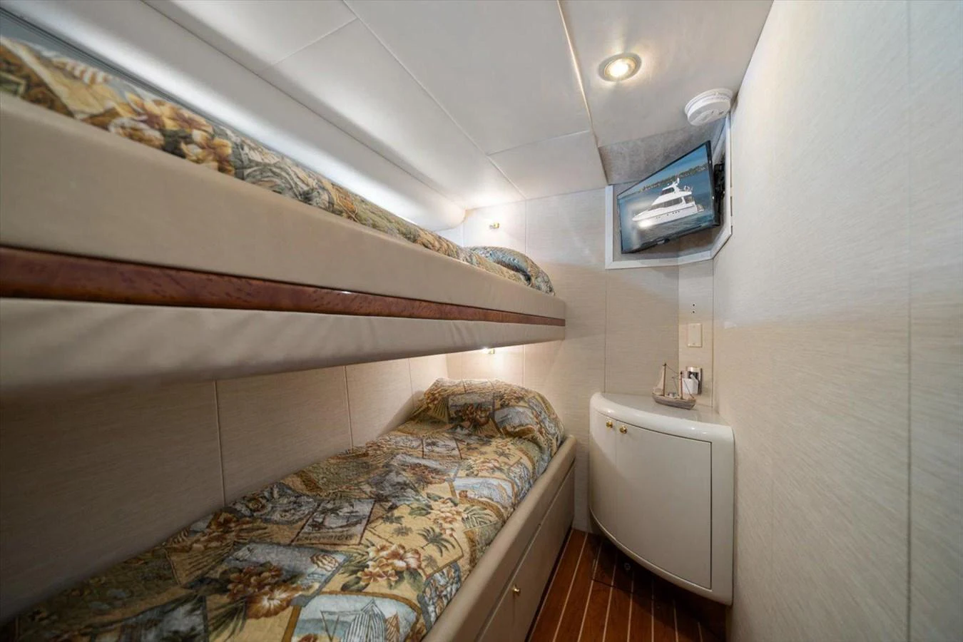 A cozy guest cabin with bunk beds and a television. aboard OCTOPI Yacht for Sale
