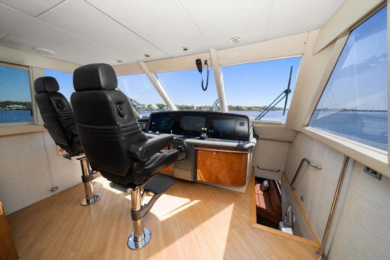 The helm station features modern navigation equipment and comfortable seating with panoramic views. aboard OCTOPI Yacht for Sale