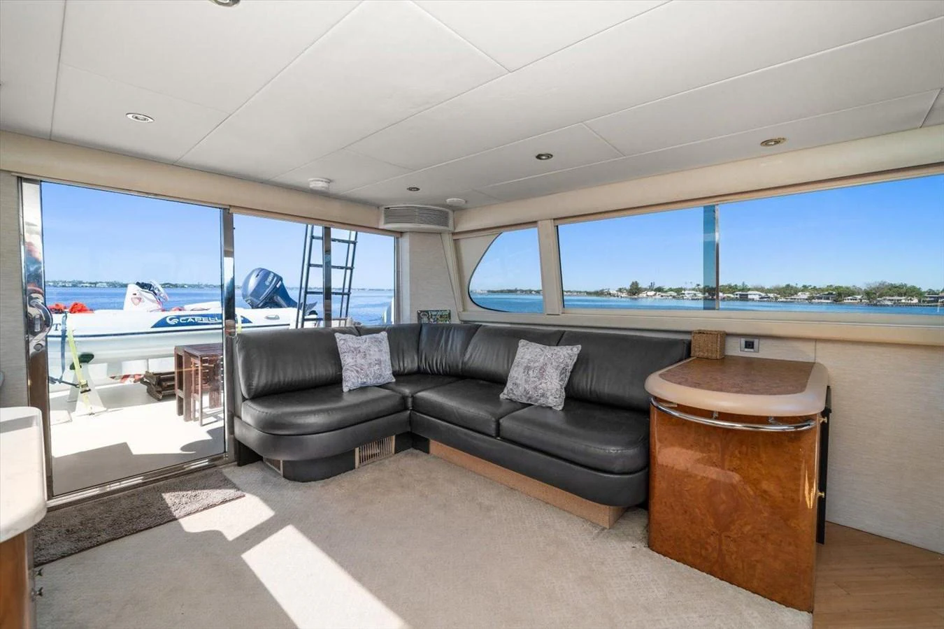The salon features a comfortable seating area with large windows offering stunning views. aboard OCTOPI Yacht for Sale