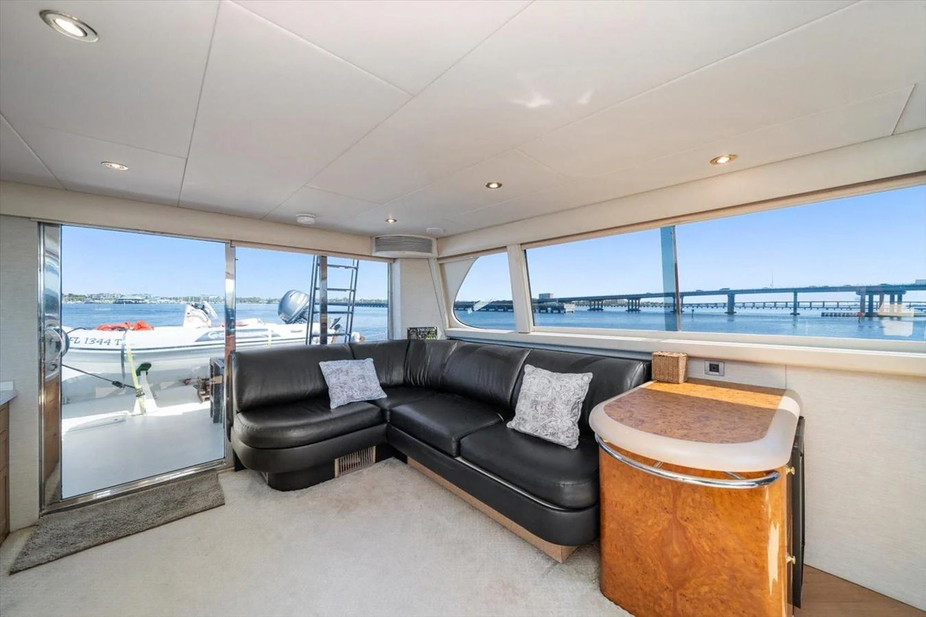 The salon offers a comfortable seating area with panoramic views through large windows. aboard OCTOPI Yacht for Sale
