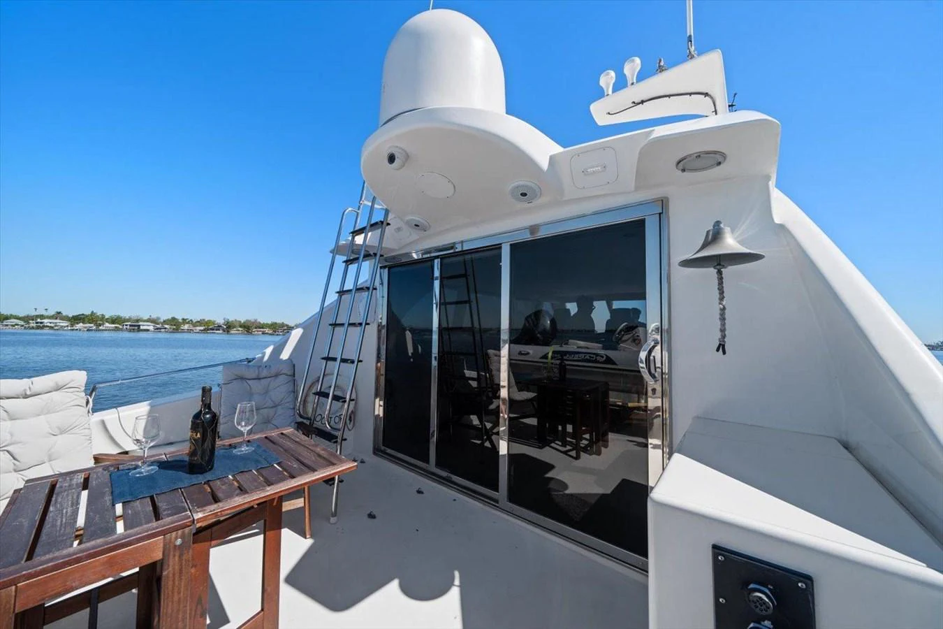 The aft deck offers a relaxing space with a table set for drinks, perfect for enjoying the view. aboard OCTOPI Yacht for Sale