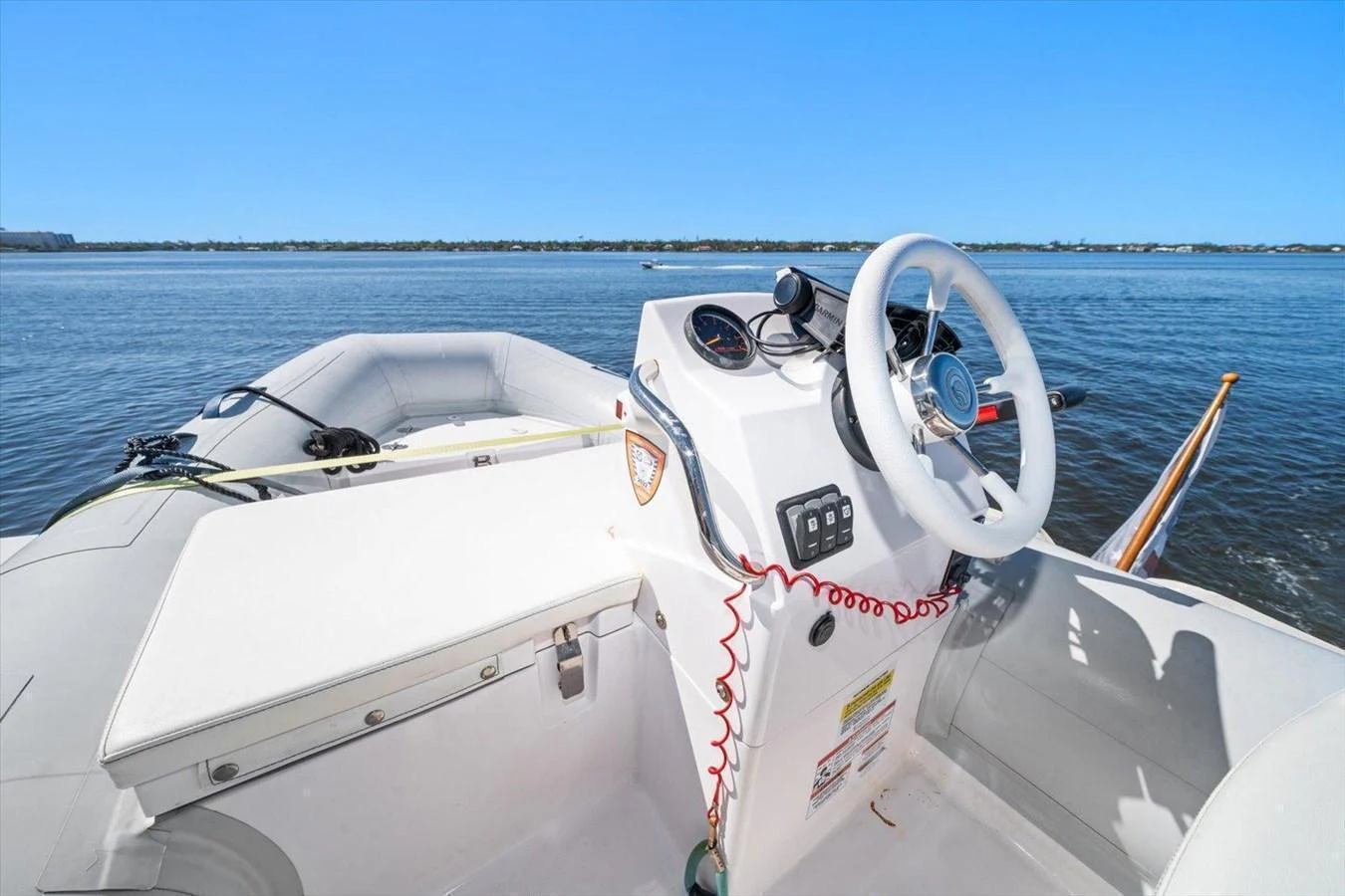 A sleek tender with a white helm and comfortable seating, cruising on calm waters. aboard OCTOPI Yacht for Sale