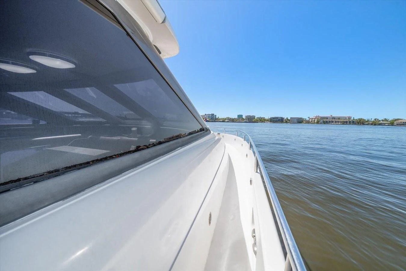 The yacht glides smoothly on calm waters under a clear blue sky. aboard OCTOPI Yacht for Sale
