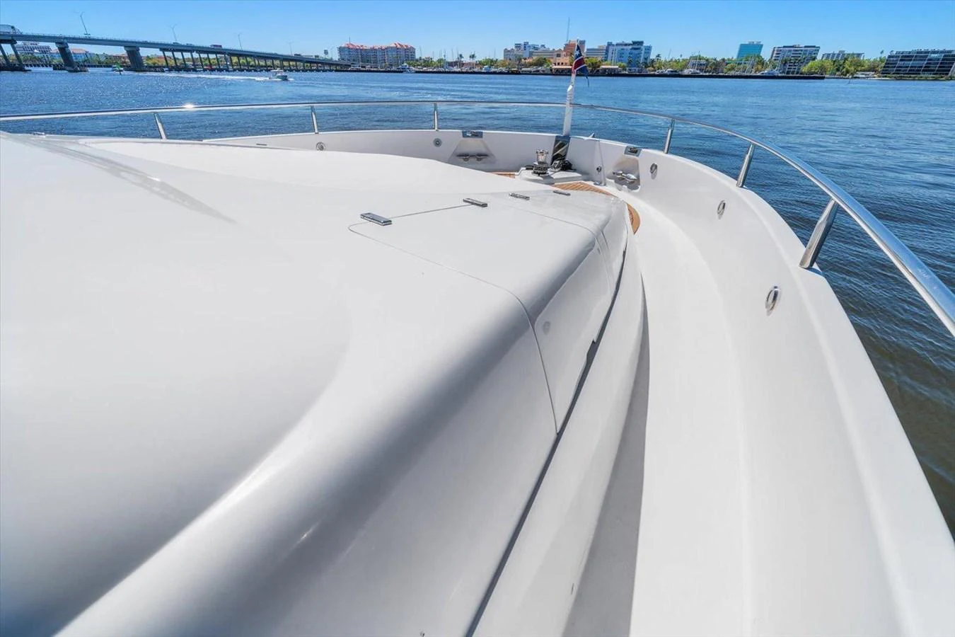 The yacht's sleek bow cuts through the water, offering a glimpse of the surrounding cityscape. aboard OCTOPI Yacht for Sale